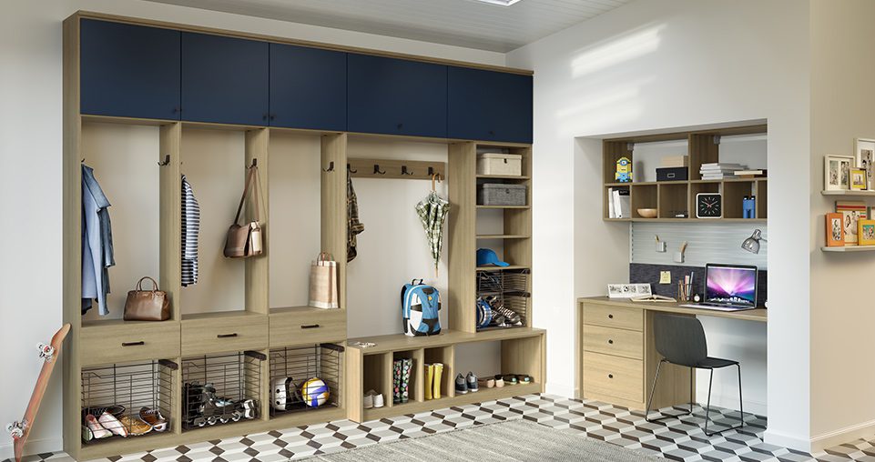 Mudroom custom designed for the entryway, with a light wood grain finish with blue accents and drawers.