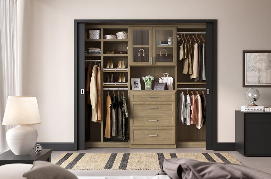 Reach in closet in a wood grain finish with black accents, custom designed by California Closets.