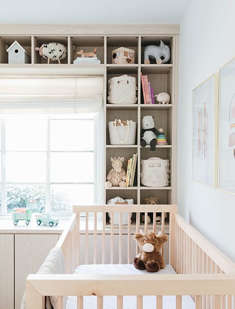 Custom home office with a shelving system designed by California Closets with a crib