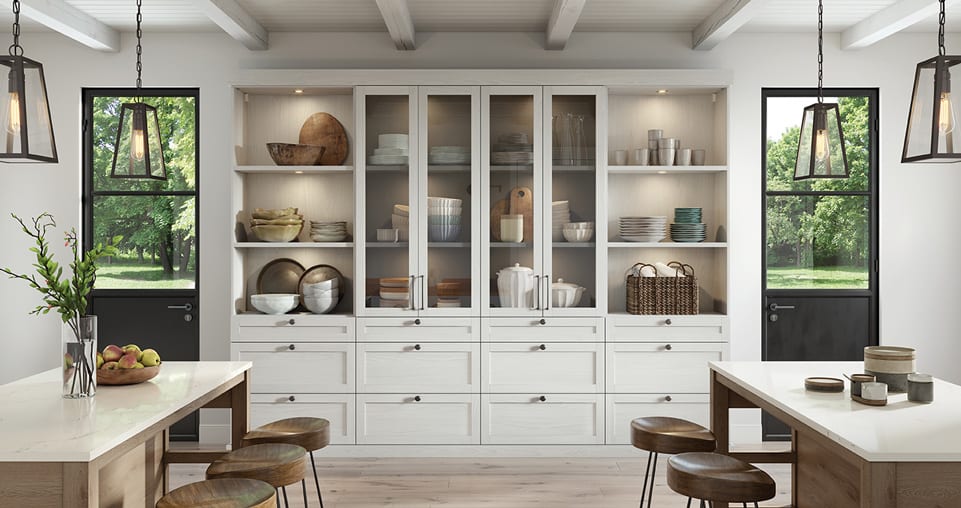 Custom pantry with accent lighting, glass doors and pull out drawers for storage.