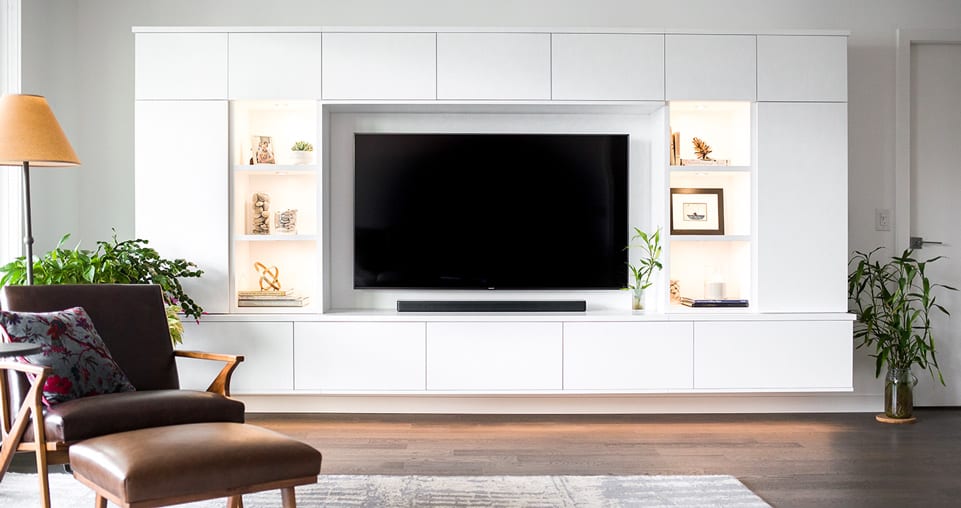 Entertainment center with accent lighting and shelving shown in a with white finish design to your budget.