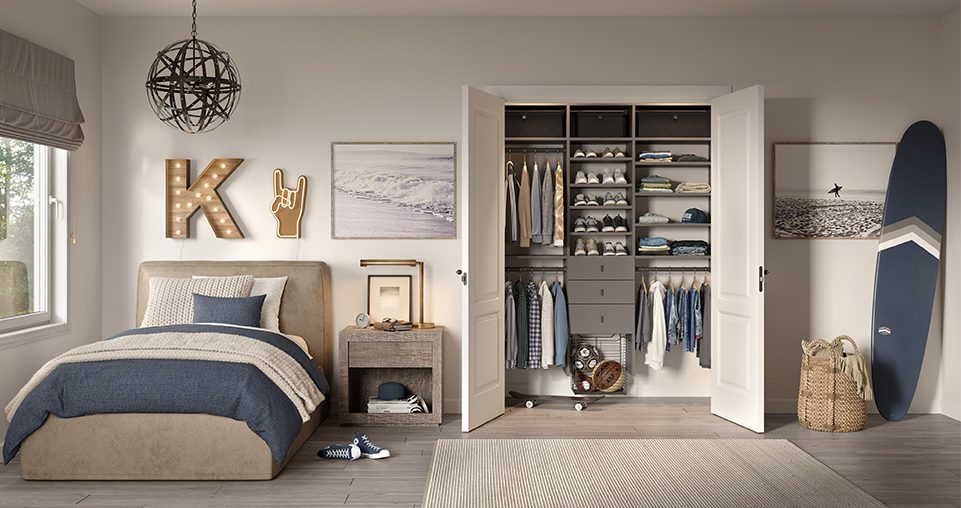 Reach in closet in grey matte finish with custom drawers and hanging racks created by California Closets