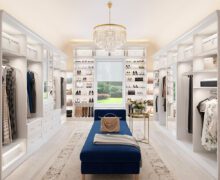 Luxe walk in closet with shoe storage, custom cabinets and open shelving by California Closets