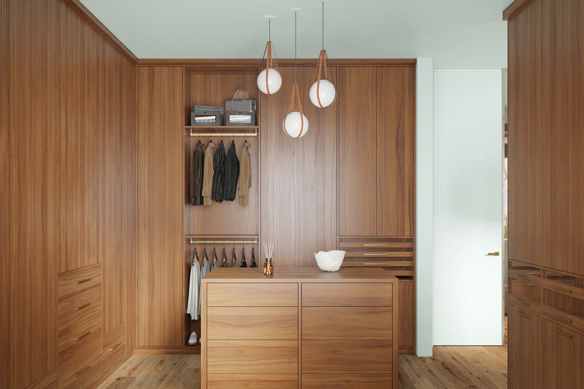 A modern, minimalist walk in closet in natural wood grain finish with floor to ceiling cabinets and center island created by California Closets
