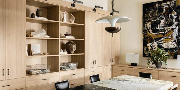 Interior designer, Jeremiah Brent’s custom office designed with cabinets, shelving and drawers in a light wood grain finish created by California Closets