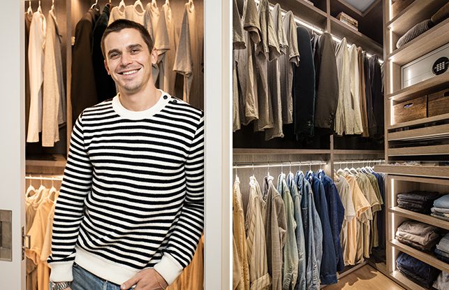 Antoni Porowski in his newly designed walk in closet with custom shelves and drawers in a light wood grain finish by California Closets