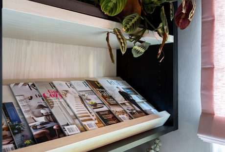 Office turned cloffice with magazine storage for an editor, in light wood grain finish by California Closets