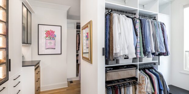 His closet is designed in a white wood grain finish with custom shelving and drawers created by California Closets