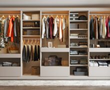 Reach in closet organization with open shelves, custom drawers and clothes poles by California Closets
