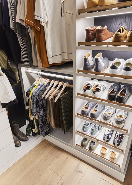 Titled shoe storage organization in Bobby Berk’s walk in closet designed by California Closets