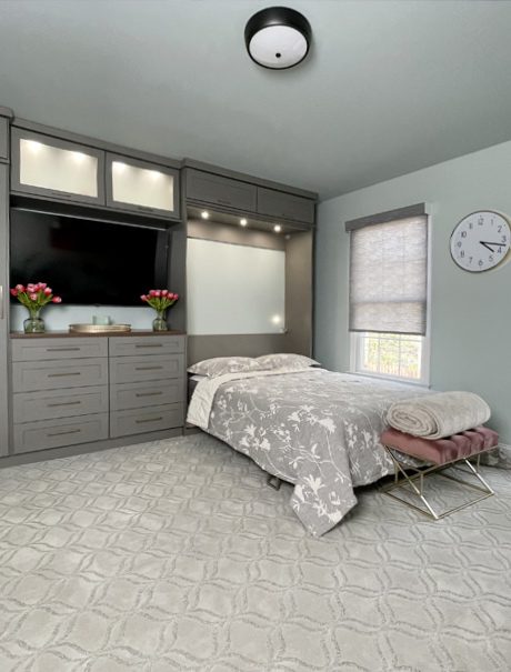 Murphy bed design opened with custom built in cabinets, drawers and LED lighting created by California Closets
