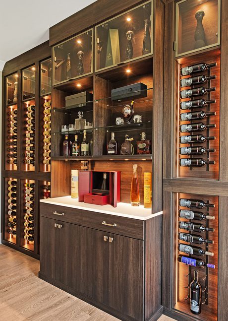 Luxe home bar design in dark wood grain finish custom made by California Closets