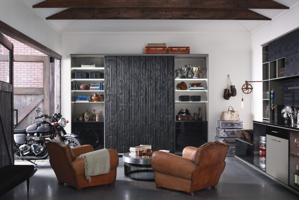 Entertainment center with home bar and storage solutions repurposed from a garage space by California Closets