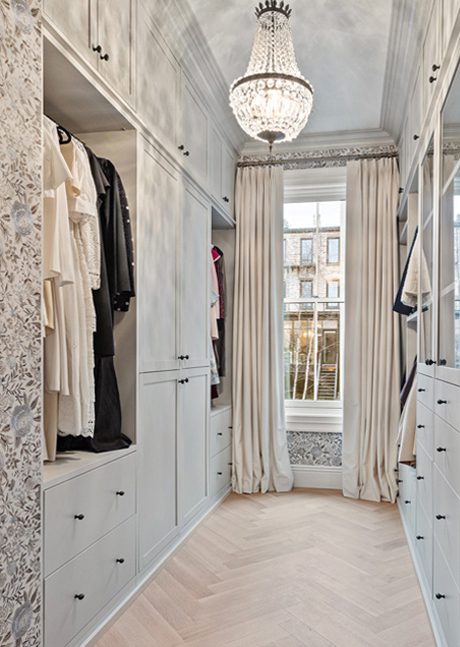 Custom walk in closet with floor to ceiling storage, open shelves an drawer space by Califoria Closets