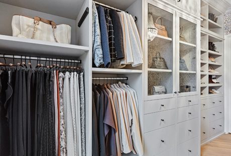 Walk in closet design with open shelves and glass doors with custom drawers by Califoria Closets